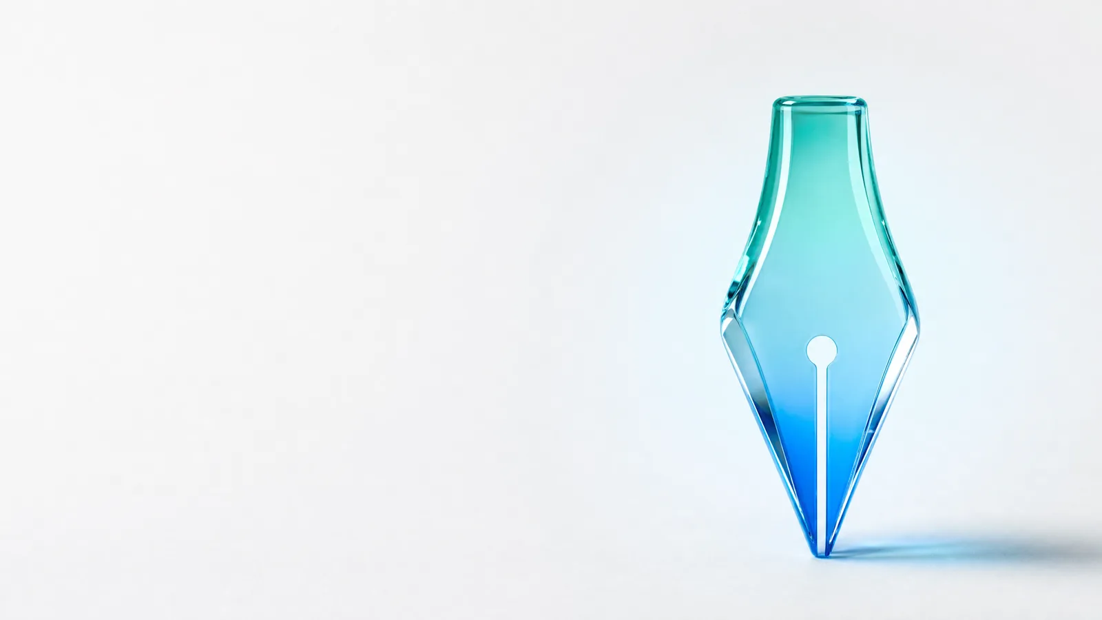 Abstract glass object in ALPENIQ blue: fountain pen nib rendered in glass